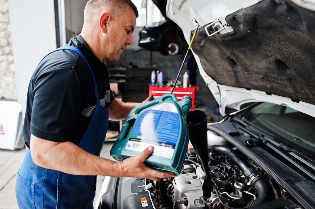 car-repair-maintenance-theme-mechanic-uniform-working-auto-service-pouring-new-motor-oil_627829-3974